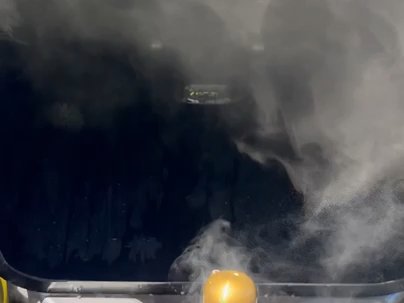 Hot water pressure washing inside a trash bin